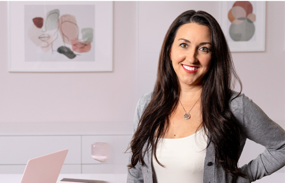 Photo of Britney Beck of Hi-Wire HR Consulting in an office, with a button link to learn more about Consultant Retainer and another button link to schedule a consultation